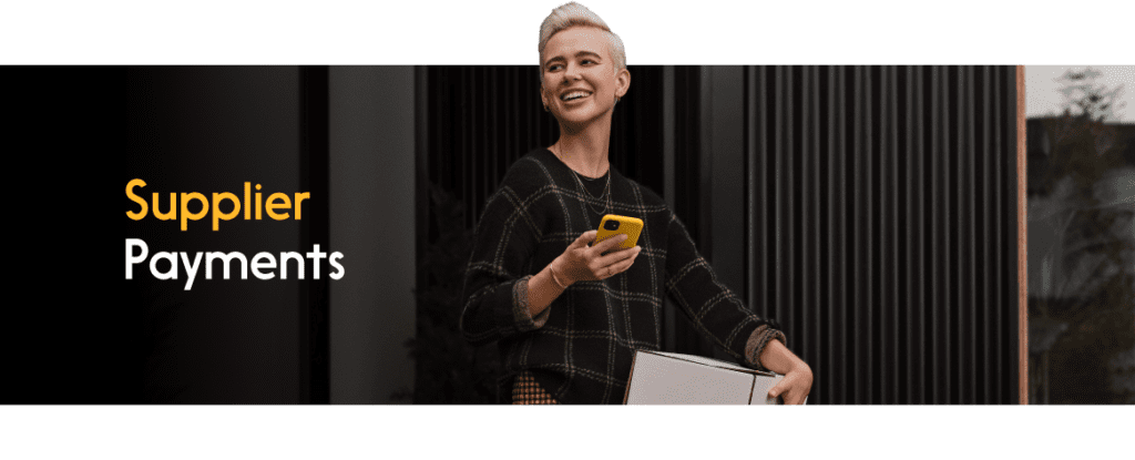 A person holding a package and a phone