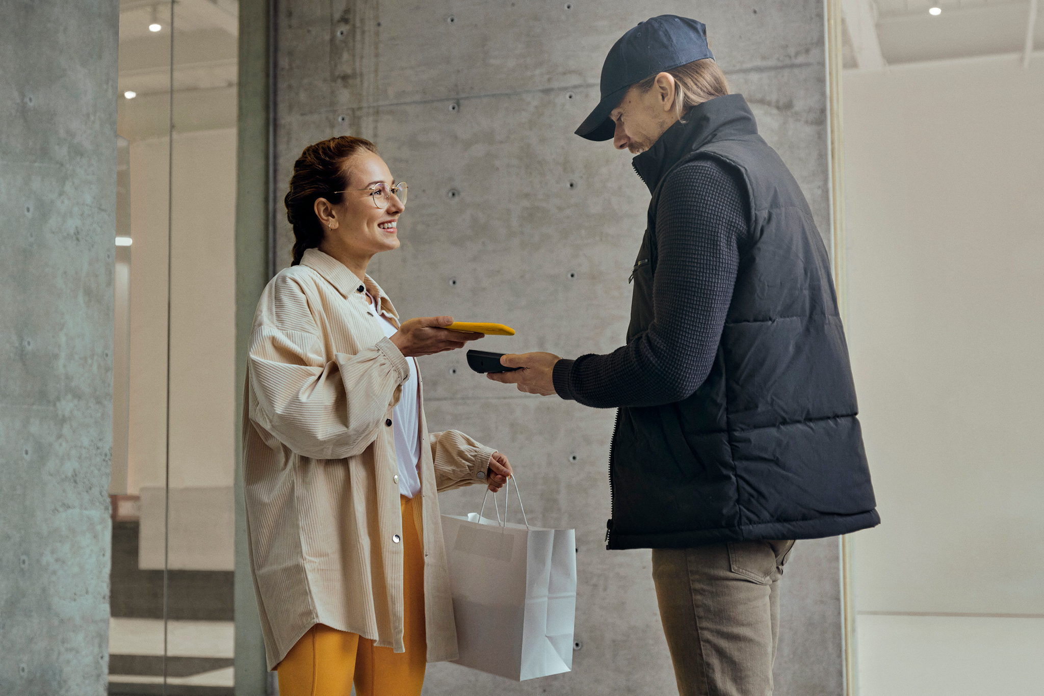 Woman enjoys paying for delivery with the speed of using mobile wallet while remaining contactless.