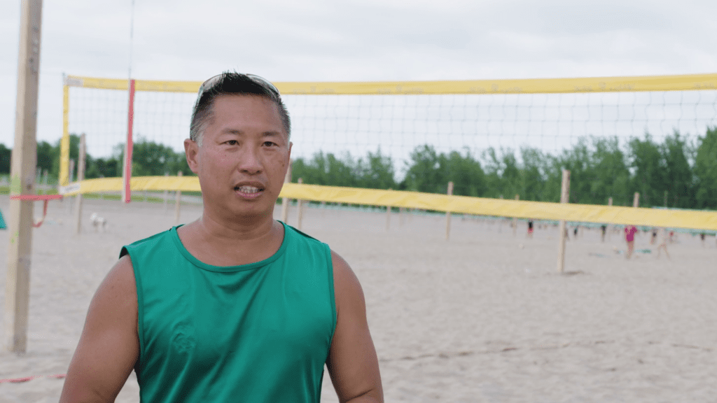 Un homme sur la plage parle des avantages de Virement Interac pour des paiements plus rapides