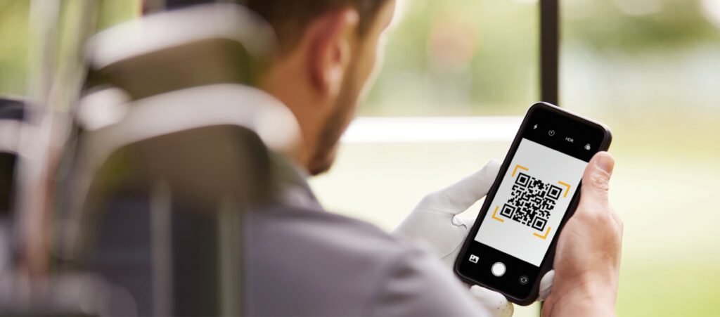 Photo: A man views his smart phone, which displays a quick-reference code code to initiate an Interac e-Transfer.