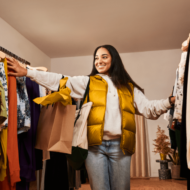 Image of a shopper looking at clothing in an apparel store