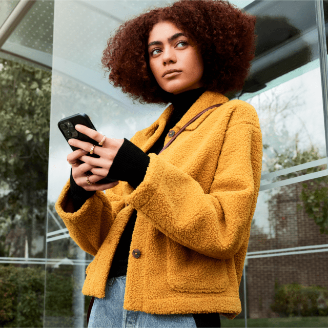 Woman looking pensive while holding her phone