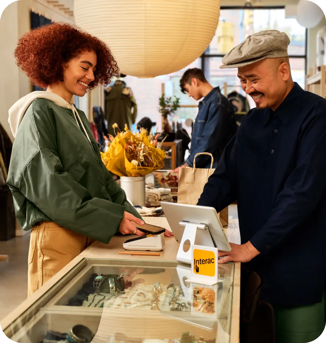 A man makes a purchase using Interac Debit at a store.